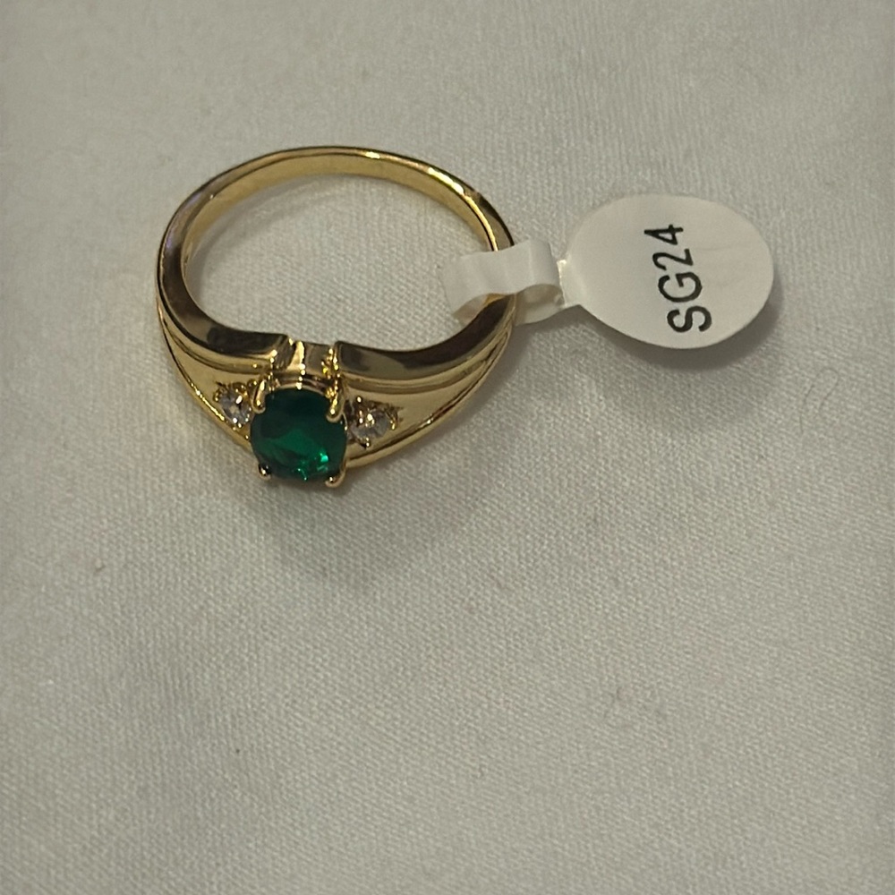 Elegant gold color ring with green stone